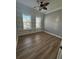 Bedroom with wood-look flooring, built-in shelving, and ceiling fan at 984 Maypole Dr, Apopka, FL 32703