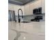 Modern kitchen island with quartz countertop and black faucet at 984 Maypole Dr, Apopka, FL 32703