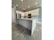 Modern kitchen with large island and white cabinets at 984 Maypole Dr, Apopka, FL 32703