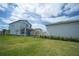The backyard features lush green grass with manicured landscaping and a view of the back of the home at 9856 Sharpless Aly, Orlando, FL 32827