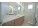 Bathroom with double sink vanity, bright lighting and frameless glass shower at 9856 Sharpless Aly, Orlando, FL 32827