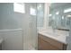 Bathroom featuring bright lighting, a double sink vanity, and frameless glass shower at 9856 Sharpless Aly, Orlando, FL 32827