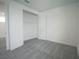 A bright bedroom featuring closet with wire shelving and neutral carpet at 9856 Sharpless Aly, Orlando, FL 32827
