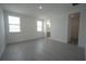 Bedroom features durable wood-style floors, natural light from two windows, and access to bath and closet at 9856 Sharpless Aly, Orlando, FL 32827