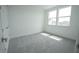 A bright bedroom with two large windows and neutral carpet at 9856 Sharpless Aly, Orlando, FL 32827
