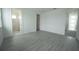 Bedroom featuring wood floors, access to bathroom with glass shower, and walk-in closet at 9856 Sharpless Aly, Orlando, FL 32827