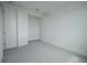 A bright bedroom featuring closet with wire shelving and neutral carpet at 9856 Sharpless Aly, Orlando, FL 32827