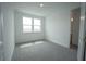 A bright bedroom with two large windows and neutral carpet at 9856 Sharpless Aly, Orlando, FL 32827