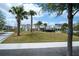 Neighborhood street with palm trees, sidewalks, green spaces, and charming residential homes at 9856 Sharpless Aly, Orlando, FL 32827