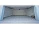 A two car garage features neutral paint, an epoxy floor, and plenty of room for storage or vehicles at 9856 Sharpless Aly, Orlando, FL 32827