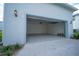 A two car garage with overhead lighting and an epoxy floor is spacious and ready for vehicles at 9856 Sharpless Aly, Orlando, FL 32827