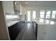 Spacious kitchen with an island, stainless steel appliances, black lower cabinets, and modern design at 9856 Sharpless Aly, Orlando, FL 32827