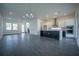 Bright and airy living room featuring recessed lighting, stairs to the second floor, and a modern kitchen at 9856 Sharpless Aly, Orlando, FL 32827