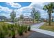 Community playground with climbing structures and swings, surrounded by lush landscaping and sidewalks at 9856 Sharpless Aly, Orlando, FL 32827