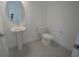 Powder room featuring a pedestal sink, gray tile floors and toilet at 9856 Sharpless Aly, Orlando, FL 32827