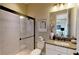 Bathroom featuring tiled walk-in shower and granite vanity with stylish decorative accessories at 987 Ladyfish Trl, St Cloud, FL 34771