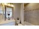 Well-lit bathroom featuring a shower-tub combo, mosaic tile details, and a modern vanity at 987 Ladyfish Trl, St Cloud, FL 34771