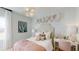 Charming bedroom featuring patterned wallpaper, a modern light fixture, and a cozy writing desk at 987 Ladyfish Trl, St Cloud, FL 34771