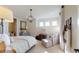 Bright bedroom with a sitting area, modern lighting, and large windows for ample natural light at 987 Ladyfish Trl, St Cloud, FL 34771