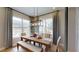 Dining room with natural light, modern chandelier, and views of the outdoor swimming pool at 987 Ladyfish Trl, St Cloud, FL 34771