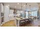Modern kitchen with a large island, pendant lighting, stainless steel appliances, and a dining area at 987 Ladyfish Trl, St Cloud, FL 34771