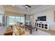 Living room with sliding glass doors to the outdoor dining area, a fireplace, and modern decor at 987 Ladyfish Trl, St Cloud, FL 34771