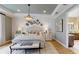 Elegant bedroom with decorative chandelier, stylish decor, and a doorway to the en-suite bathroom at 987 Ladyfish Trl, St Cloud, FL 34771