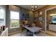 Home office with window, a desk, corkboard wall, and a view into the adjacent bathroom at 987 Ladyfish Trl, St Cloud, FL 34771