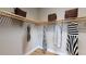Well-organized walk-in closet with custom wood shelving and ample space for clothing and accessories at 987 Ladyfish Trl, St Cloud, FL 34771