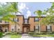 Tan two-story townhome with palm trees, shutters, and a paved walkway at 3632 Calabria Ave, Davenport, FL 33897