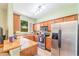 U-shaped kitchen with stainless steel appliances and granite countertops at 3632 Calabria Ave, Davenport, FL 33897