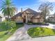 Luxury home with a large yard and circular driveway near the lake at 10018 Lone Tree Ln, Orlando, FL 32836