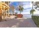 Brick paved patio overlooks tranquil lake views, creating a relaxing outdoor space at 10018 Lone Tree Ln, Orlando, FL 32836