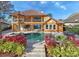 Backyard with a patio, pool, and lush landscaping, creating a relaxing and luxurious outdoor space at 10018 Lone Tree Ln, Orlando, FL 32836