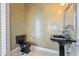 Powder room with black sink and toilet, and textured walls at 10018 Lone Tree Ln, Orlando, FL 32836