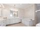 Luxurious bathroom featuring a soaking tub and marble finishes at 10018 Lone Tree Ln, Orlando, FL 32836