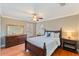 Cozy bedroom with hardwood floors and an updated dresser at 10018 Lone Tree Ln, Orlando, FL 32836
