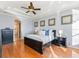 Bright bedroom with hardwood floors and ensuite bathroom access at 10018 Lone Tree Ln, Orlando, FL 32836