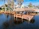 Covered dock with seating area and water access at 10018 Lone Tree Ln, Orlando, FL 32836