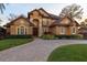 Two-story home with circular driveway and landscaping at 10018 Lone Tree Ln, Orlando, FL 32836
