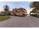 Two-story home with circular driveway and landscaping at 10018 Lone Tree Ln, Orlando, FL 32836