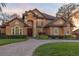 Two-story home with circular driveway and landscaping at 10018 Lone Tree Ln, Orlando, FL 32836