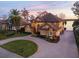 Two-story home with circular driveway and lake view at 10018 Lone Tree Ln, Orlando, FL 32836