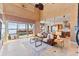 Spacious living room with high ceilings,waterfront views, and a leather sofa at 10018 Lone Tree Ln, Orlando, FL 32836