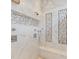 Large walk-in shower with marble tile and built-in seating at 10018 Lone Tree Ln, Orlando, FL 32836
