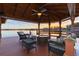 Relaxing waterfront gazebo with fire pit and seating at 10018 Lone Tree Ln, Orlando, FL 32836