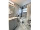 Updated bathroom with gray vanity and marble-look flooring at 1018 4Th St, Port Orange, FL 32129