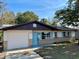 Charming ranch home with a light blue door and well-maintained lawn at 1018 4Th St, Port Orange, FL 32129
