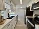 Updated kitchen with stainless steel appliances and white shaker cabinets at 1018 4Th St, Port Orange, FL 32129