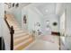 Bright entryway with staircase, tile floors, and wall art at 10233 Henbury St, Orlando, FL 32832